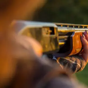 A person holding a gun in their hand.