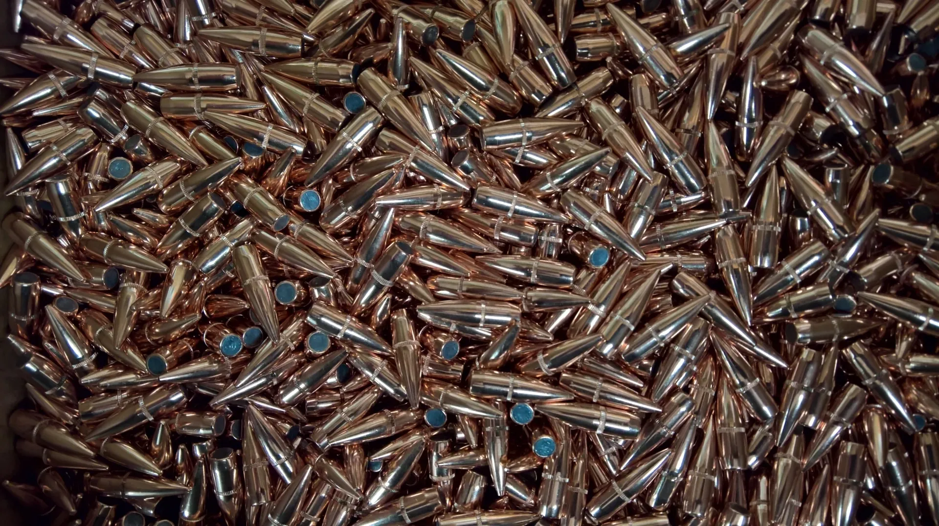 A pile of bullet casings that are sitting on the ground.