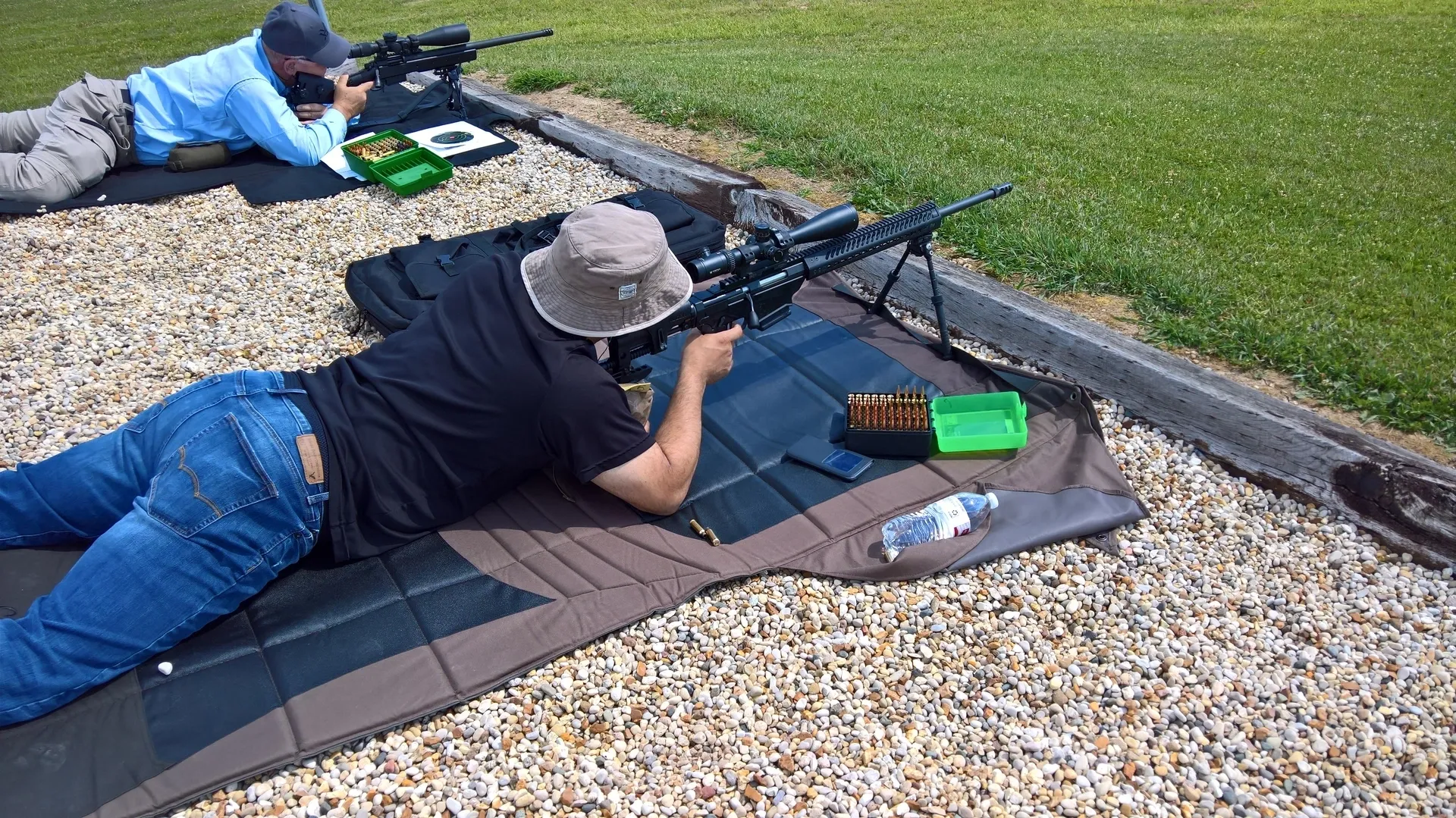 A man laying on the ground with a rifle.